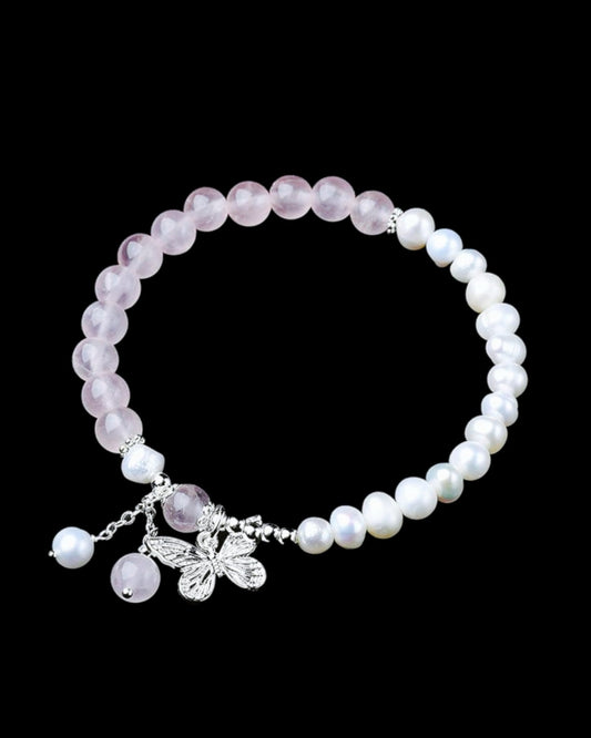 Beautiful Rose Quartz & Pearl Bracelet with a butterfly charm, designed to attract love, self-confidence, and emotional balance. A timeless piece for spiritual healing.
