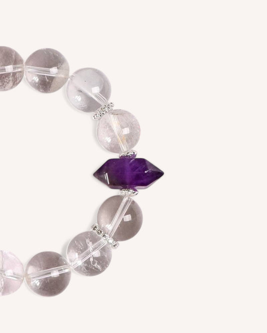 A handcrafted healing bracelet featuring clear White Quartz beads and a faceted Amethyst gemstone, promoting focus, clarity, and emotional stability.