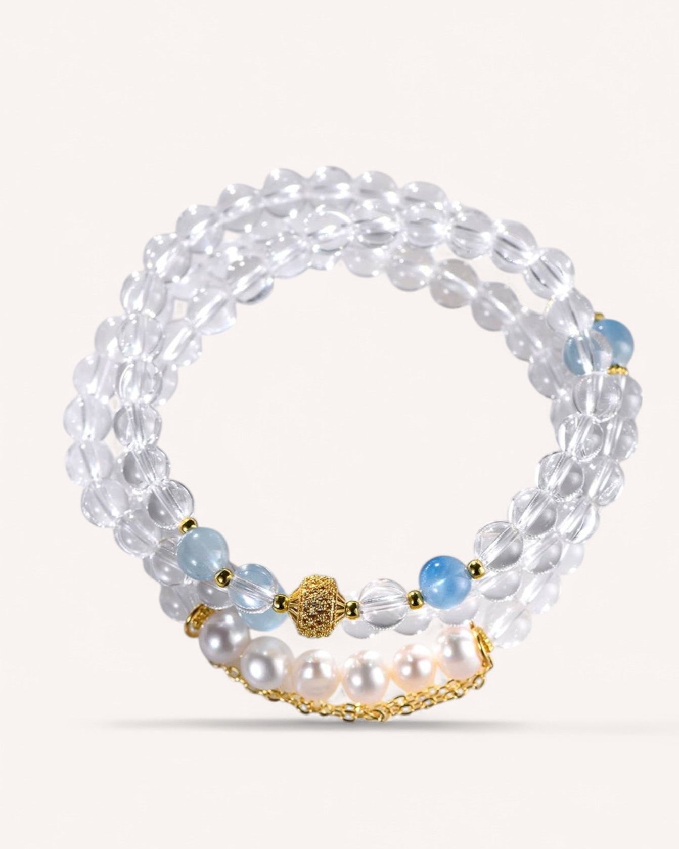 A multi-layer White Quartz bracelet featuring Aquamarine & Pearl accents, designed for emotional healing, clarity, and intuition. A perfect piece for meditation, balance, and inner strength.
