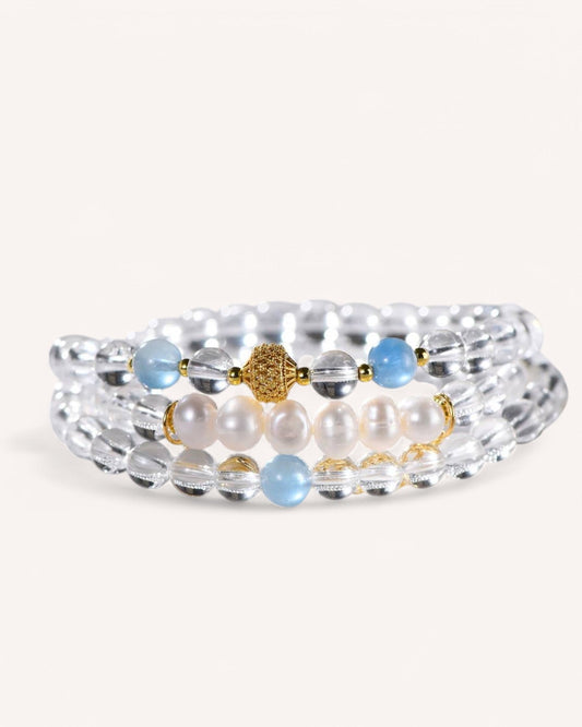 A beautifully crafted multi-layer bracelet with White Quartz, Aquamarine, and Pearls, offering serenity, wisdom, and energy purification. Ideal for stress relief and mindfulness.