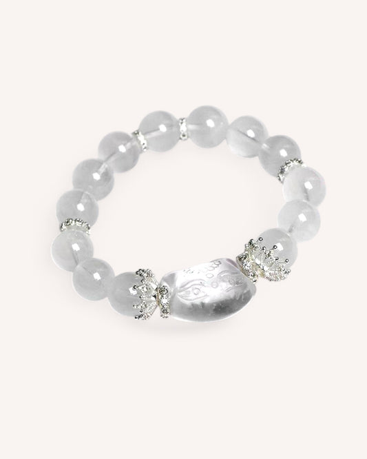 Elegant White Phantom Quartz healing bracelet with smooth white beads and a spiritual charm, enhancing focus and intuition.