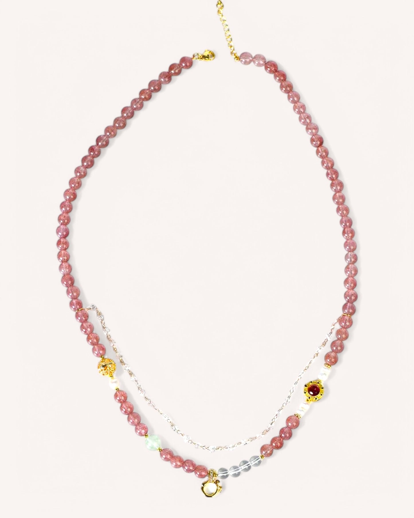 Adjustable multi-layer Strawberry Quartz crystal chain styled as a necklace, promoting love, balance, and spiritual awareness.
