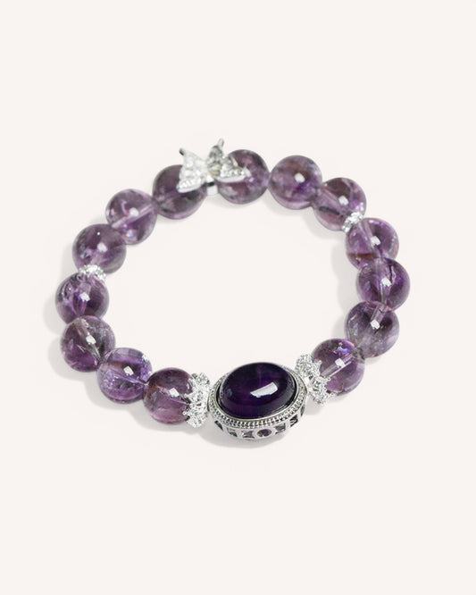 Side angle of an amethyst energy bracelet, showcasing the intricate silver setting around the oval gemstone, designed to enhance intuition and block negativity.
