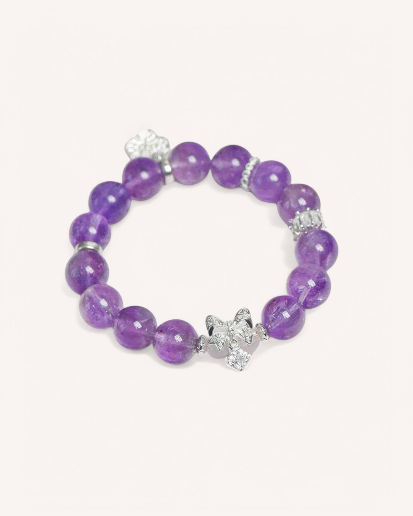 Side angle of an amethyst healing bracelet with a silver lotus charm, designed to enhance intuition, energy protection, and inner peace.