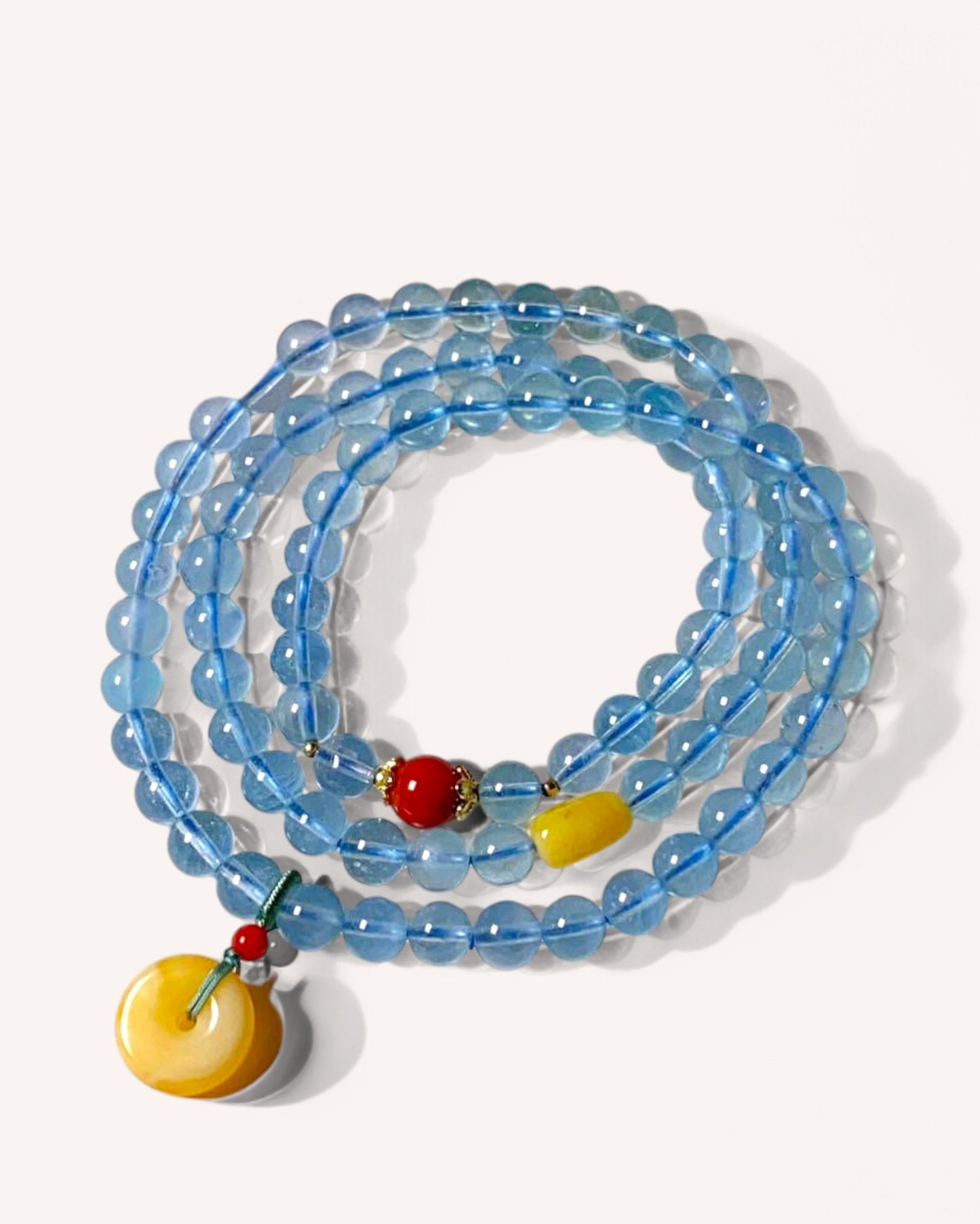 Triple-layer aquamarine and amber bracelet for emotional balance, inner peace, and mental clarity, featuring soothing blue crystals and warm amber beads.