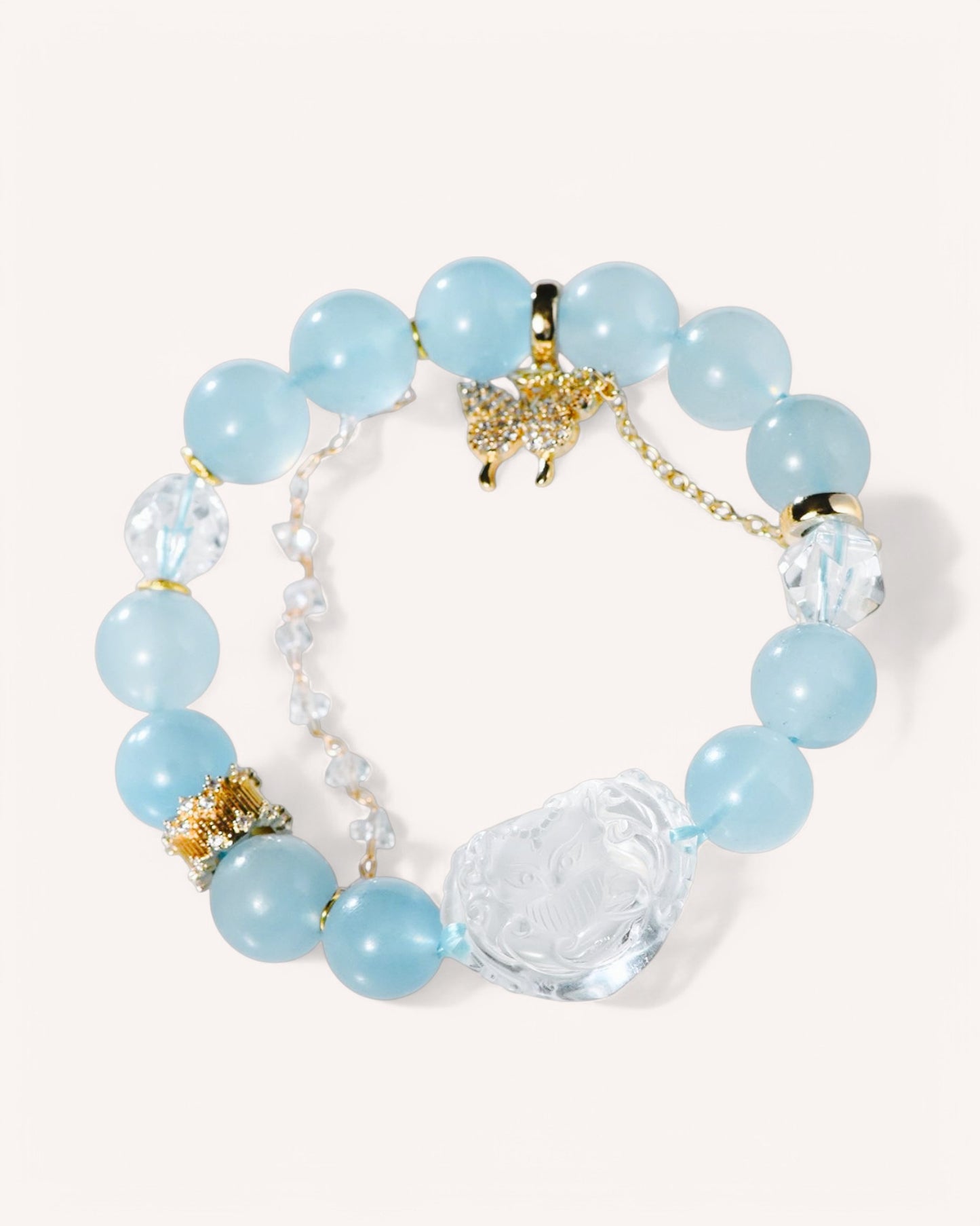 Close-up of healing bracelet featuring aquamarine beads and a white quartz Nine-Tailed Fox charm for intuition and confidence