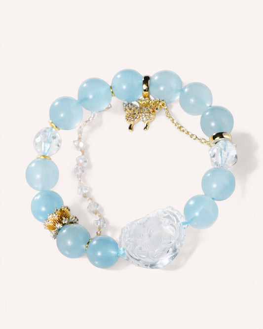 Close-up of healing bracelet featuring aquamarine beads and a white quartz Nine-Tailed Fox charm for intuition and confidence