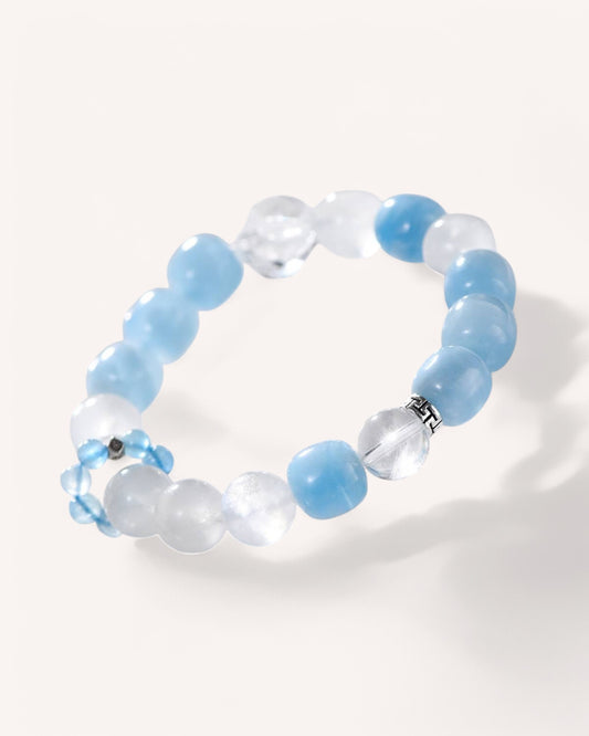 Flatlay of Aquamarine, White Quartz, and Moonstone bracelet showcasing natural crystal beads for spiritual growth and tranquility