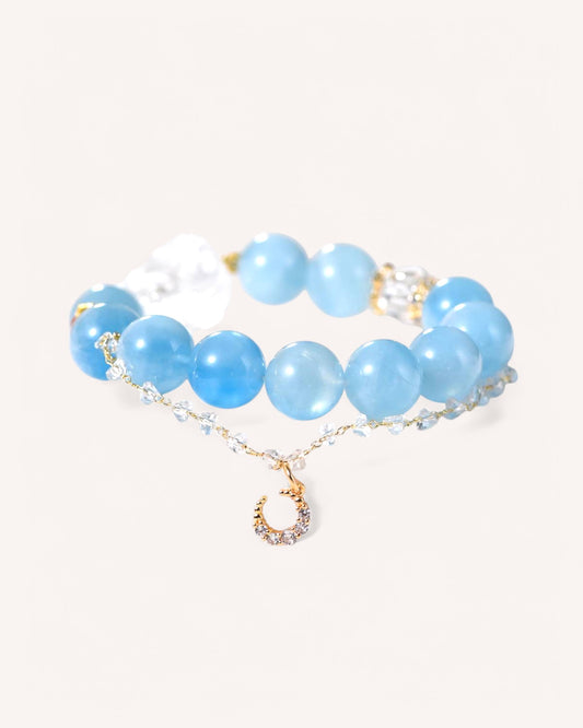 Elegant aquamarine and white quartz bracelet with golden accents for inner peace and energy protection