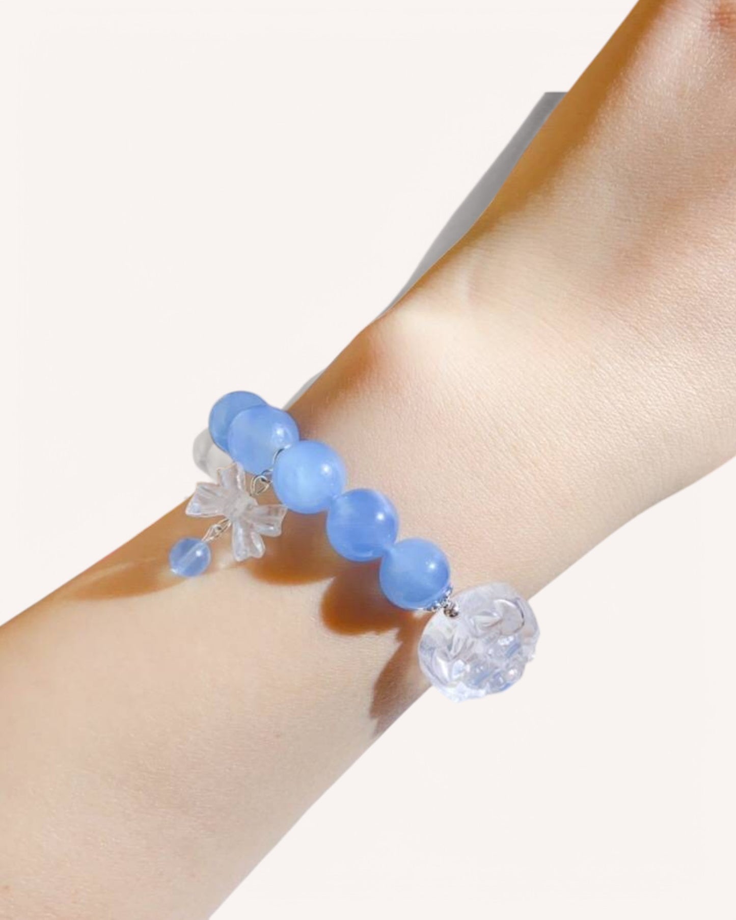 Woman wearing aquamarine and white quartz bracelet for peace and self-expression