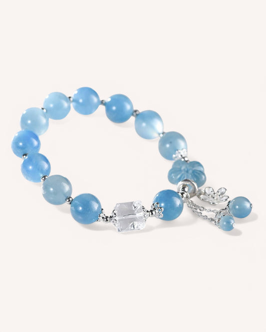 Side angle of calming Aquamarine and White Quartz crystal bracelet featuring silver accent and charm for stress relief and clarity.