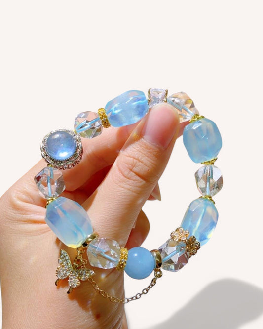 Healing aquamarine and white quartz bracelet shown in hand, ideal for emotional clarity and inner peace