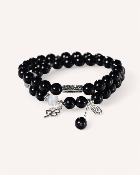 Front view of double-layer Black Obsidian and Cat’s Eye bracelet with silver wealth charm for prosperity and protection