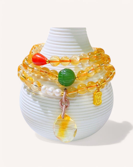 Citrine & Jade Wealth Bracelet Display – Showcased on a decorative stand, this multi-layer bracelet combines Citrine for prosperity, Jade for wisdom, and Red Agate for protection, making it a powerful spiritual accessory.