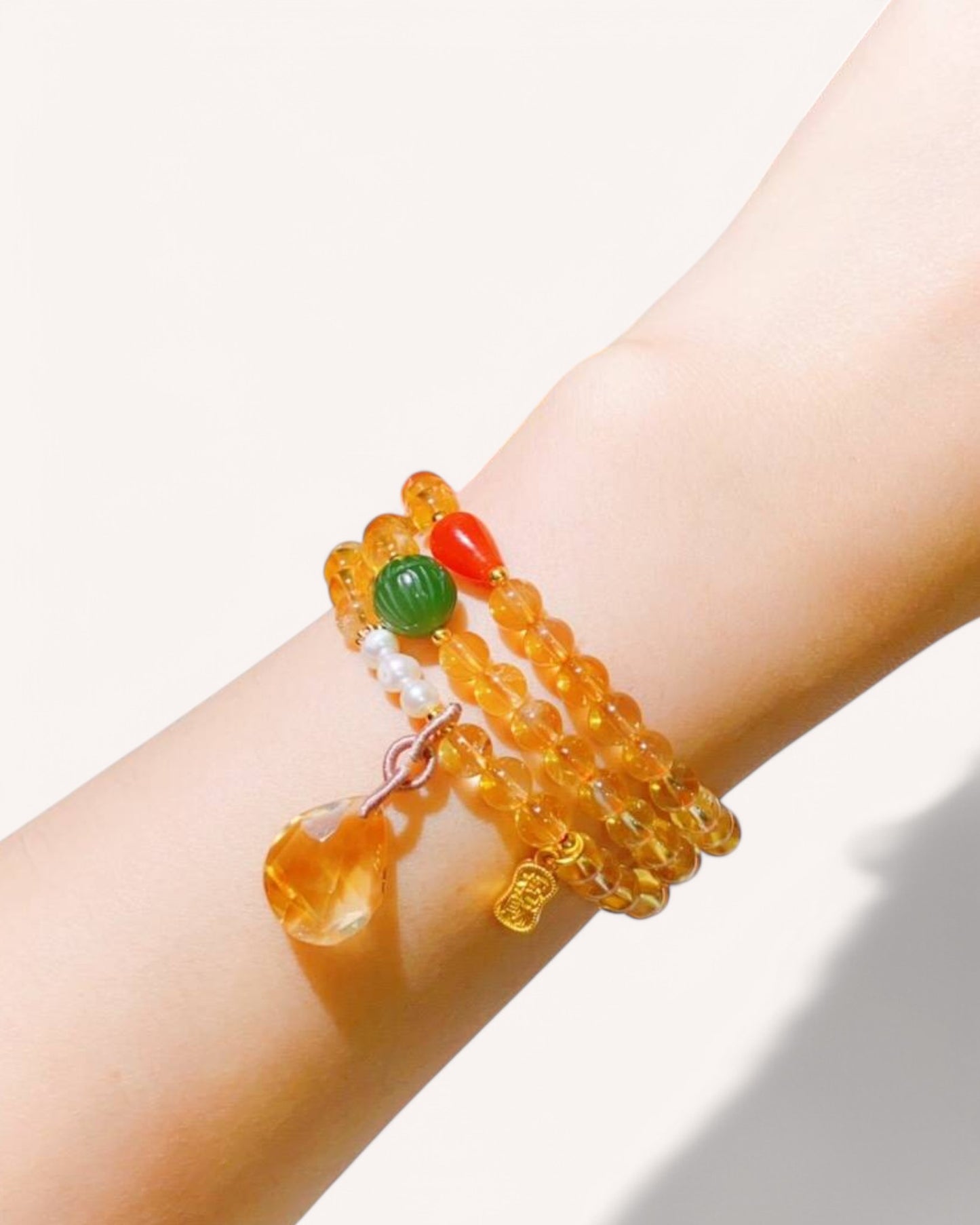 Citrine & Jade Multi-Layer Bracelet on Wrist – A handcrafted crystal bracelet featuring Citrine, Pearl Jade & Red Agate. Designed to attract wealth, confidence, and emotional balance while providing grounding and protection.