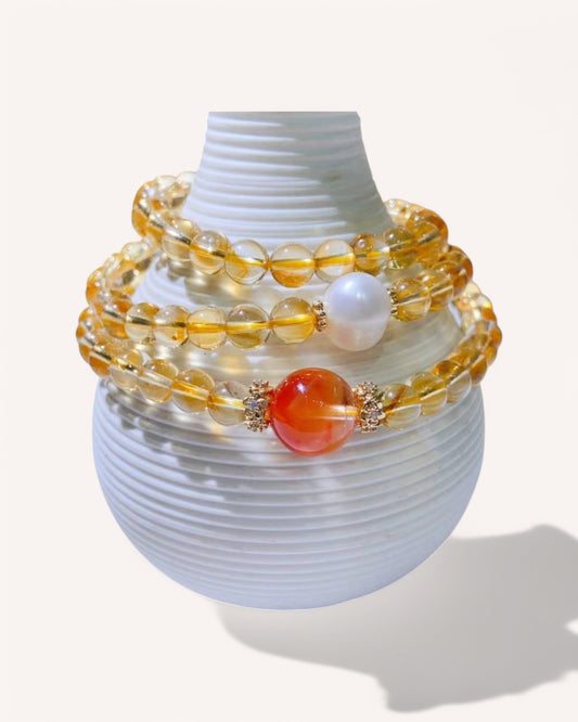 Citrine & Rutilated Quartz Energy Bracelet – A powerful multi-layer healing bracelet infused with abundance, emotional strength, and clarity. Showcased with Pearl and Red Rabbit Hair Quartz for love and self-empowerment.
