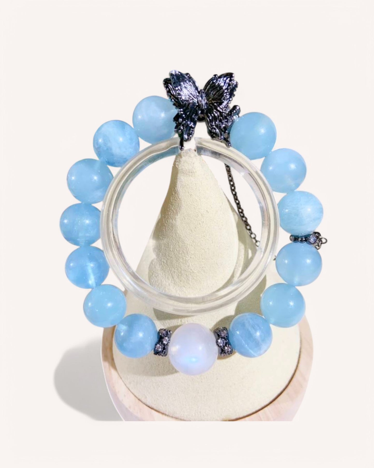 Aquamarine and Blue Moonstone bracelet with butterfly charm promoting emotional healing and spiritual clarity