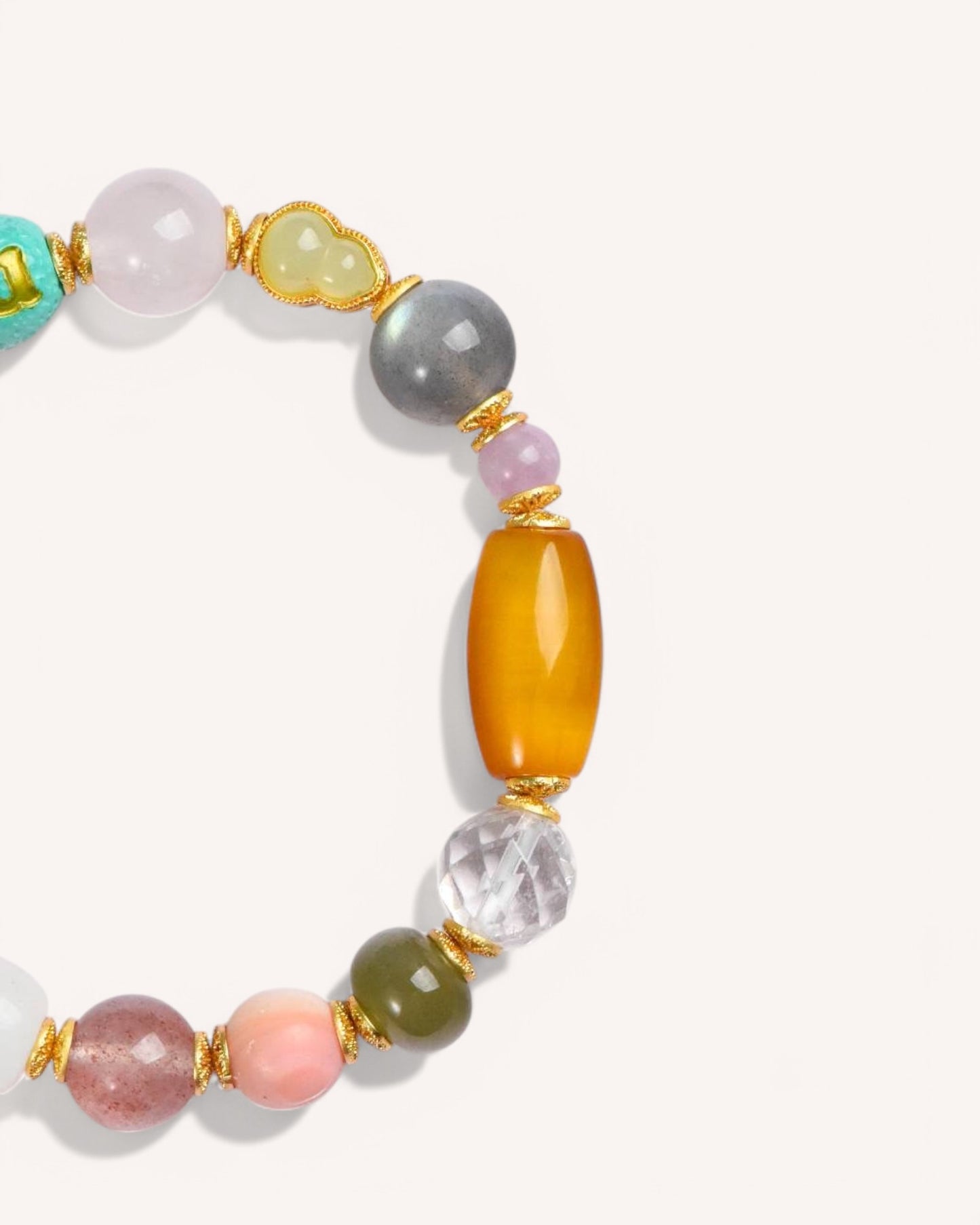 Close-up of healing crystal bracelet featuring Pink Yanyuan Agate, Gray Moonstone, and Turquoise for balance and grounding