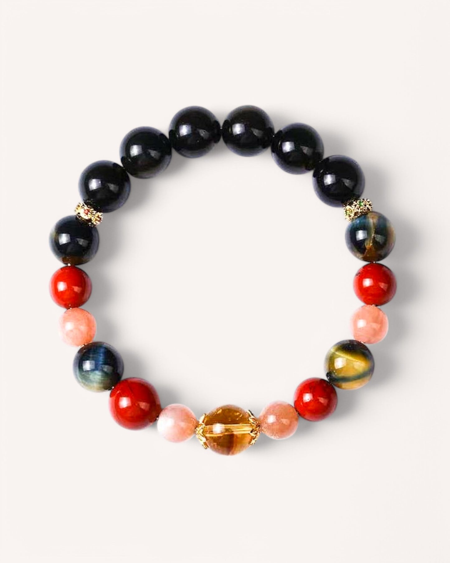 Crystal healing bracelet made with Black Obsidian, Tiger’s Eye, Red Agate, Citrine, and Sunstone for protection, confidence, and emotional stability.