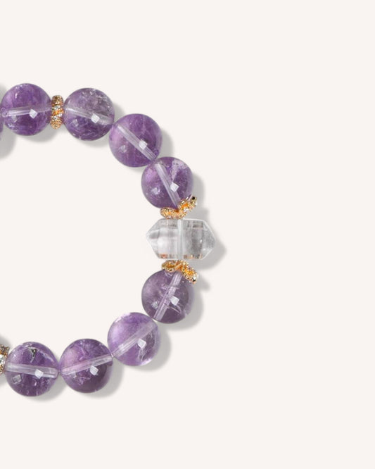 Detailed shot of Amethyst & White Quartz bracelet highlighting the healing properties of the double-point crystal for intuition and energy alignment.