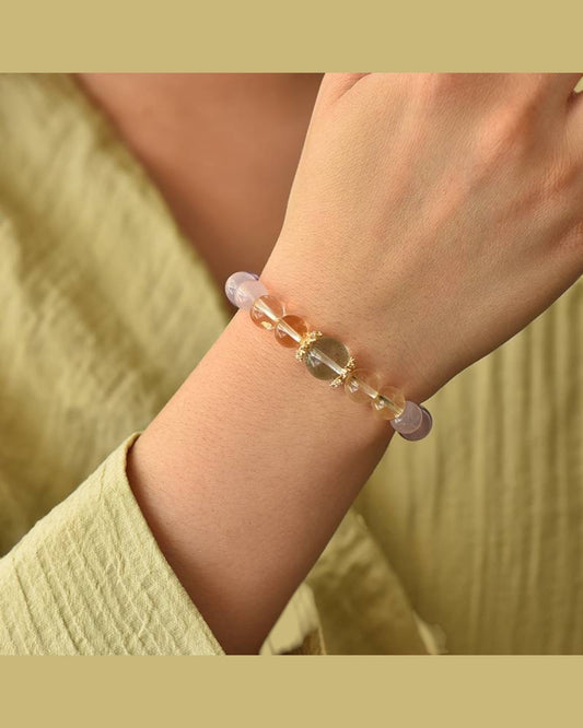 A Harmony & Protection Crystal Bracelet featuring White Quartz, Amethyst, Rose Quartz & Prehnite worn on a wrist, promoting energy balance, intuition & healing.