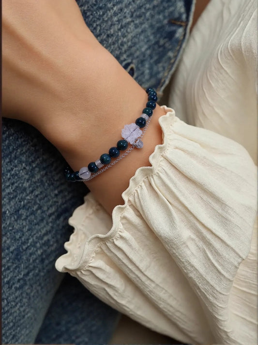 Model wearing White Quartz and Gray Moonstone bracelet with silver charm, designed for spiritual protection and emotional healing.