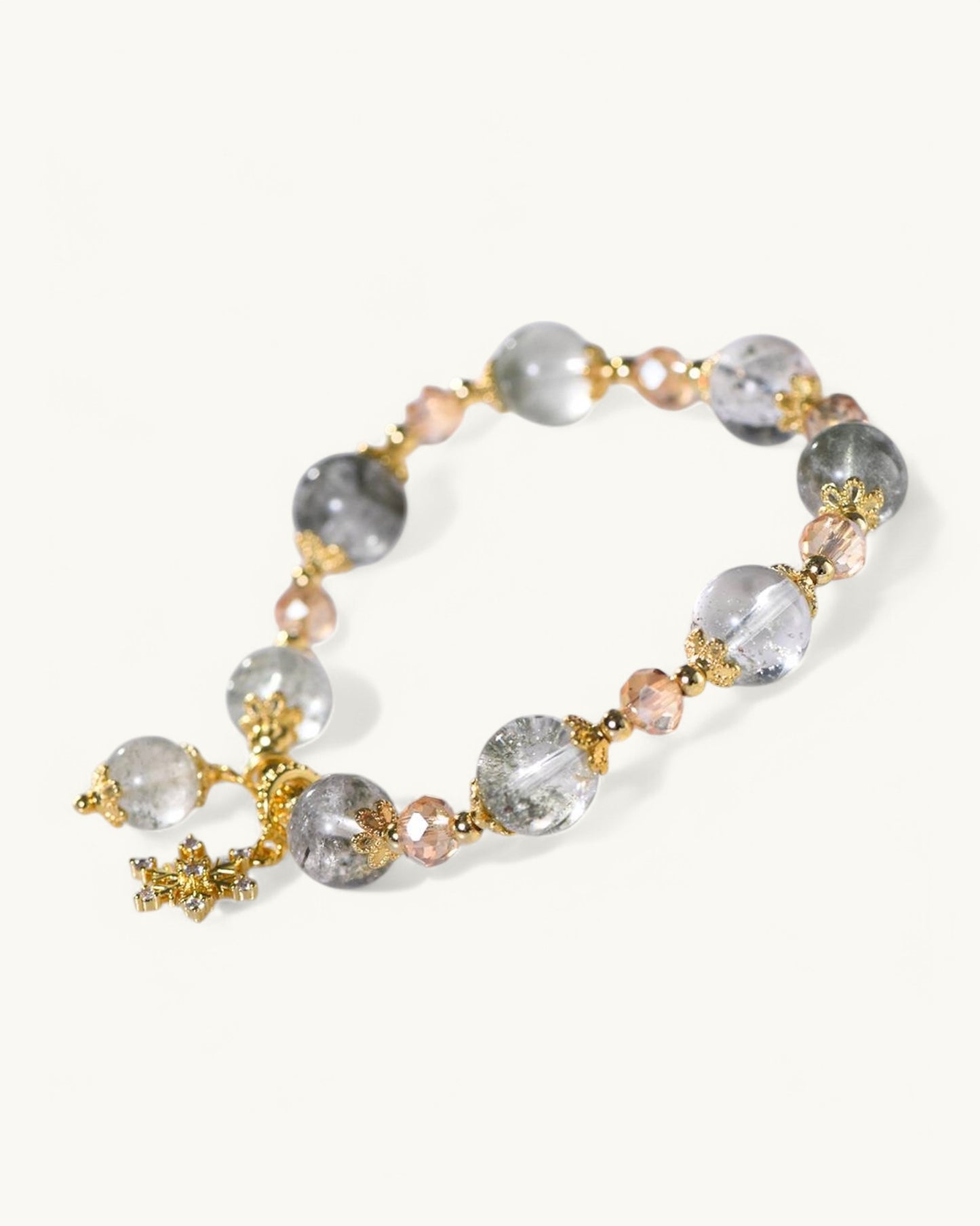Close-up of Green Phantom Quartz beads and gold accent symbolizing prosperity, intuition, and emotional clarity.