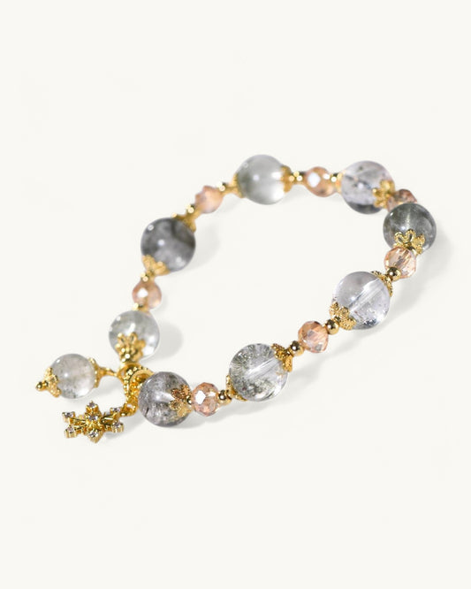 Close-up of Green Phantom Quartz beads and gold accent symbolizing prosperity, intuition, and emotional clarity.
