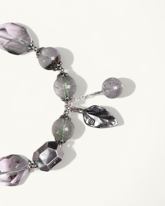 Side angle of Green Phantom bracelet featuring faceted stones and silver leaf details, designed for emotional strength and clarity.