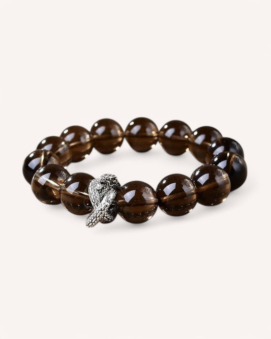 Angled close-up of Smoky Quartz bracelet with silver Spirit Snake charm, symbolizing resilience, wisdom, and grounding energy