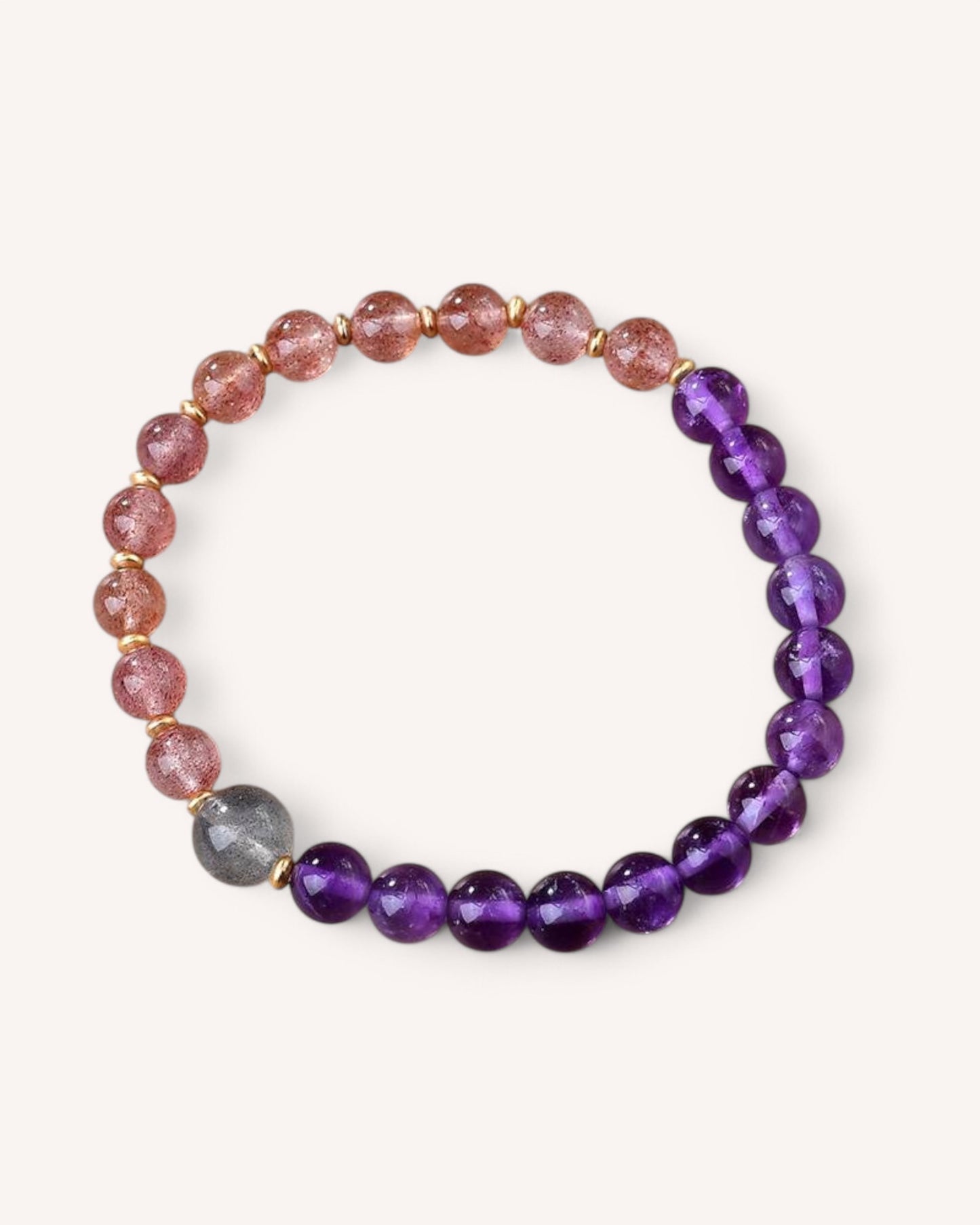 Top view of an amethyst, strawberry quartz, and gray moonstone bracelet, symbolizing love, self-awareness, and balance. This natural crystal bracelet promotes emotional clarity and spiritual harmony.