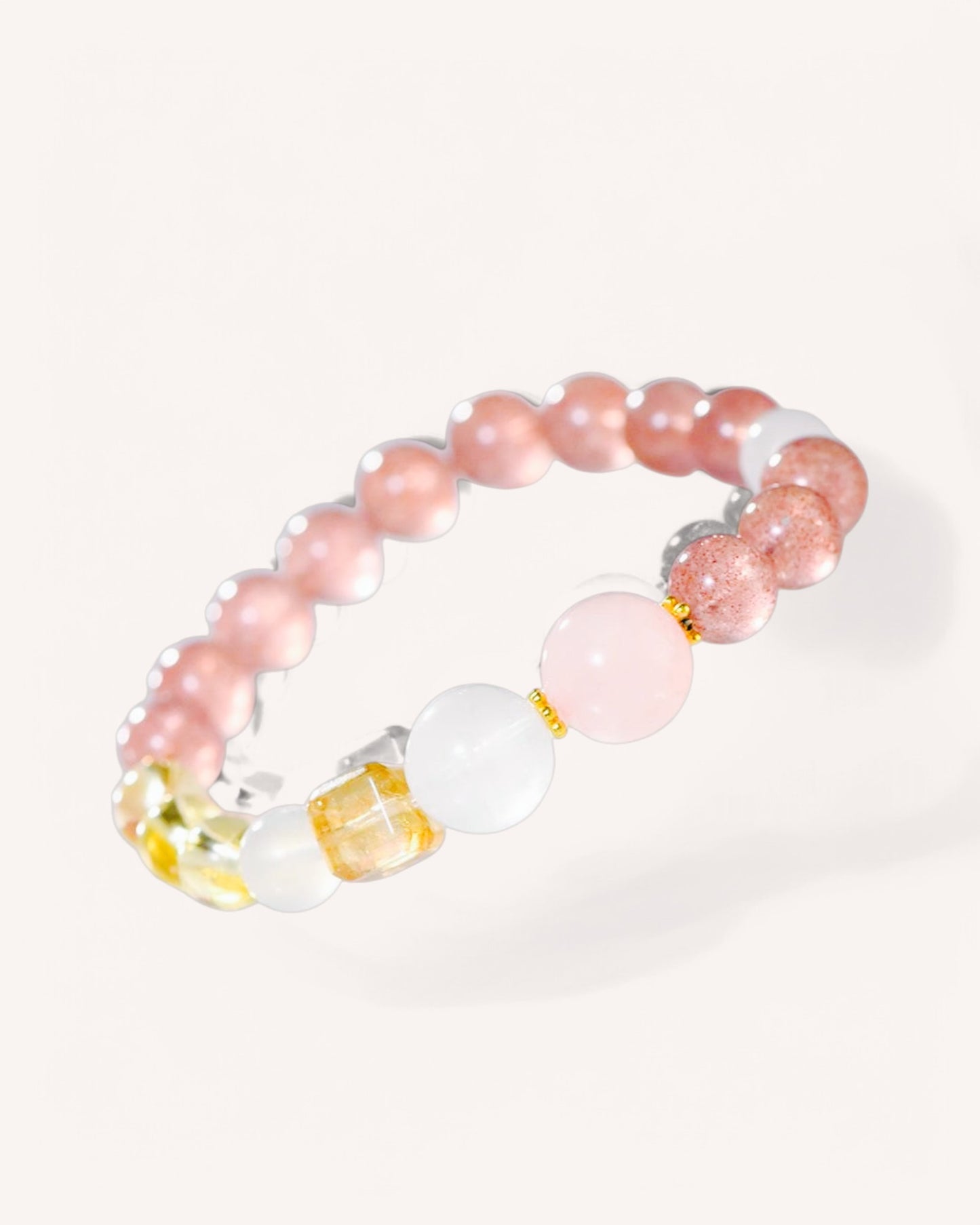 Angled view of healing crystal bracelet with Strawberry Quartz, Citrine, and Moonstone for emotional balance and success.