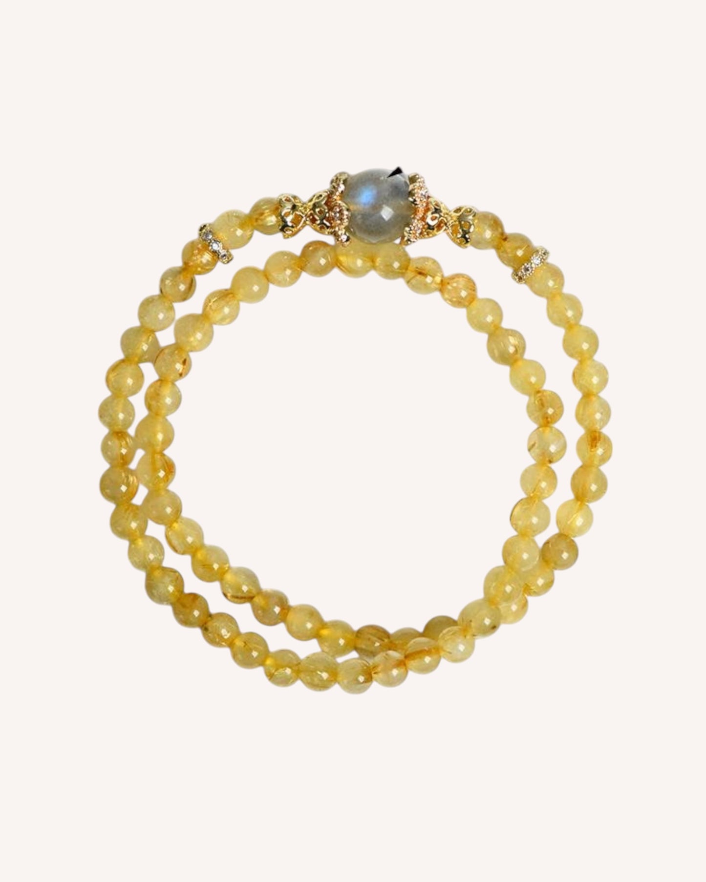 Side view of celestial energy bracelet made with Rutilated Quartz and Gray Moonstone, enhancing wisdom and grounding.