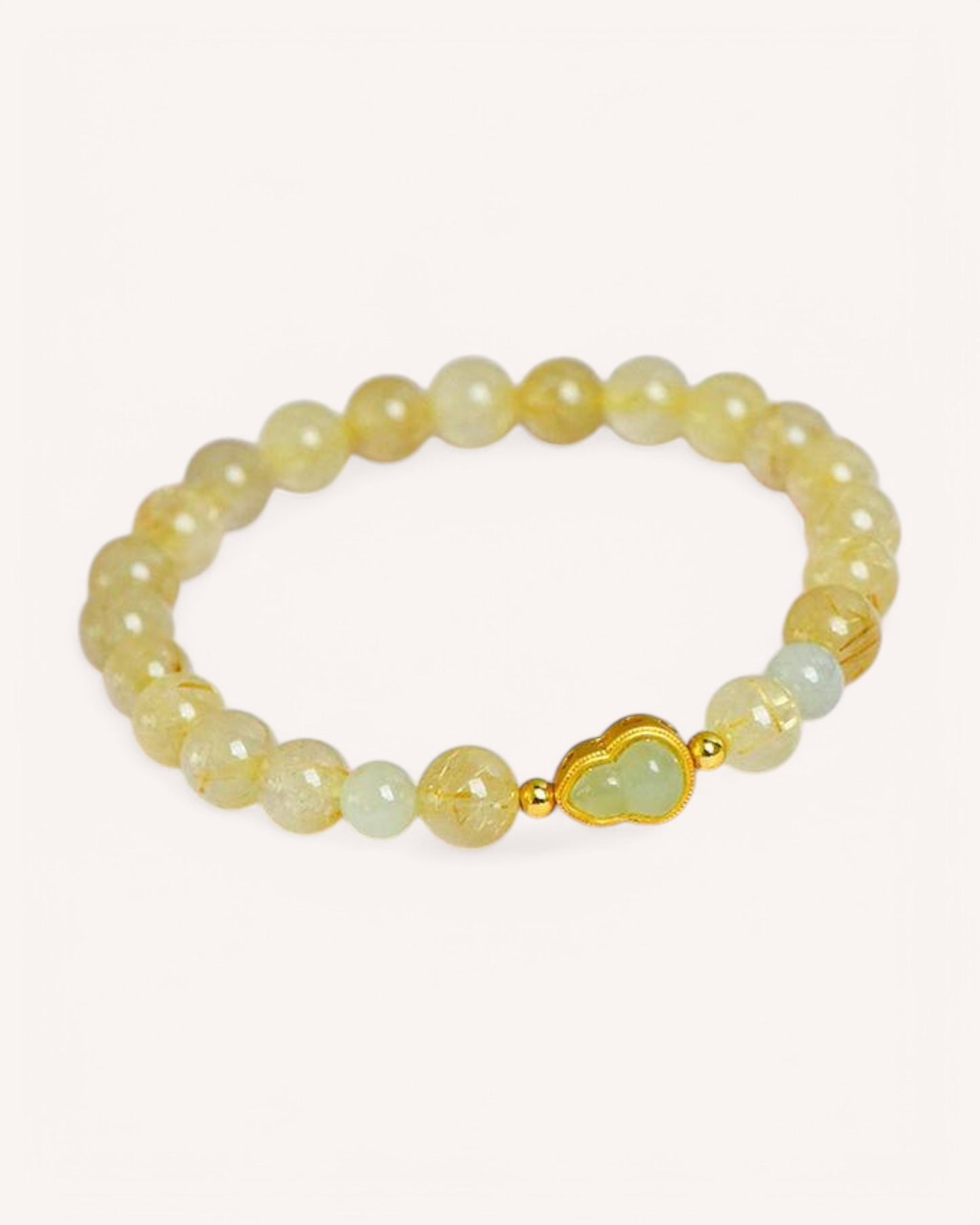 Side view of natural Hetian Jade and Rutilated Quartz bracelet with gold accents, enhancing spiritual protection and abundance