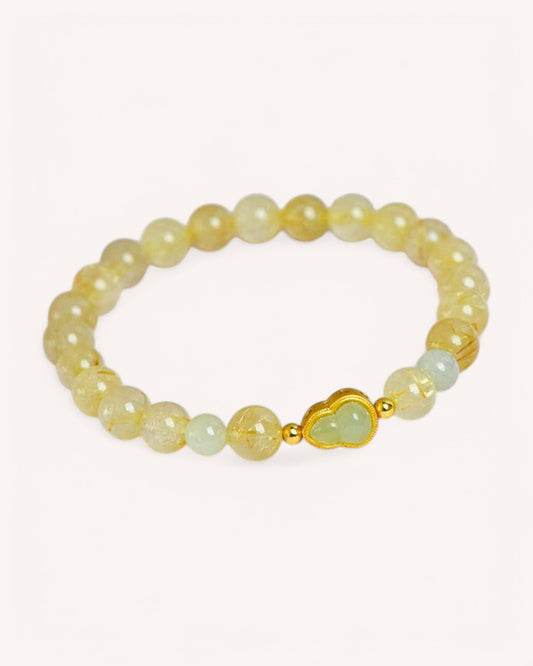 Side view of natural Hetian Jade and Rutilated Quartz bracelet with gold accents, enhancing spiritual protection and abundance