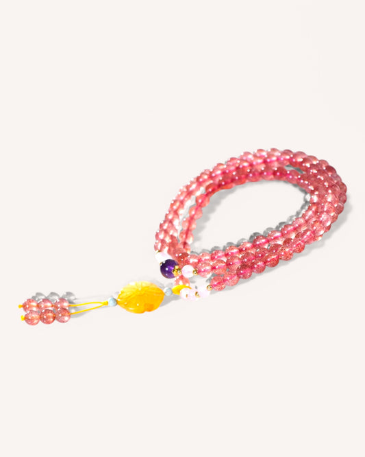 Close-up of pink crystal bracelet featuring Strawberry Quartz, Amethyst, Rose Quartz, and Amber for emotional balance and intuition.