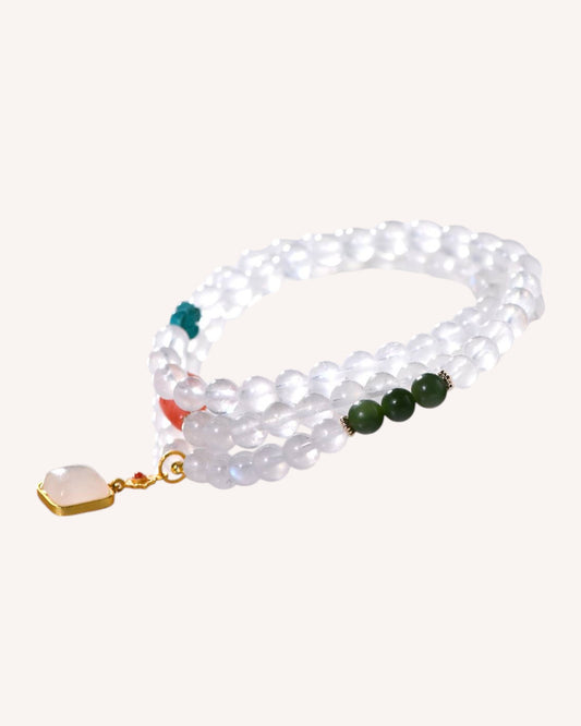 Angled image of wrap-style bracelet featuring Moonstone, Jade, Turquoise, and red agate for spiritual insight and grounding.