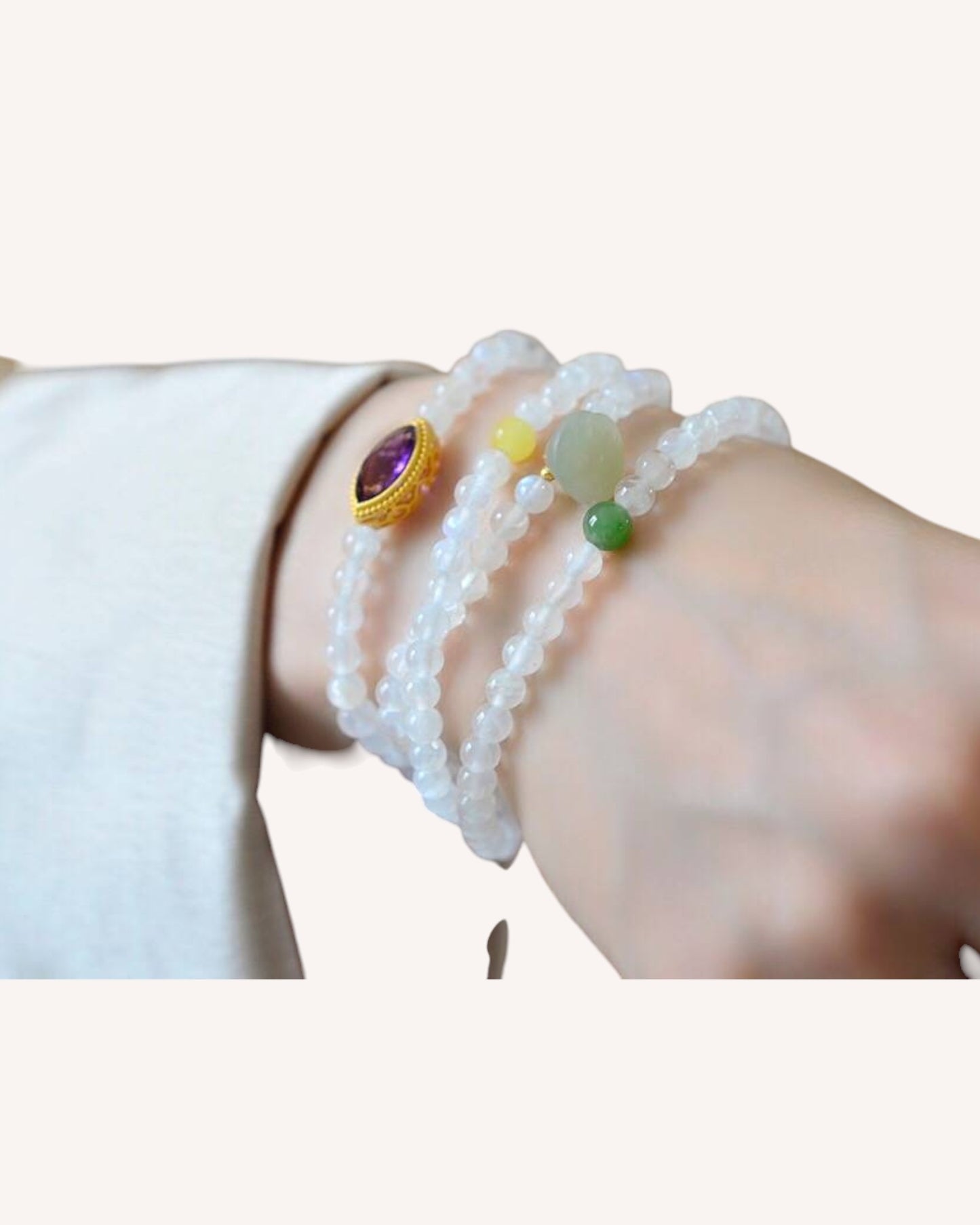 Woman wearing multi-layer Moonstone and Hetian Jade bracelet promoting spiritual harmony and emotional clarity.