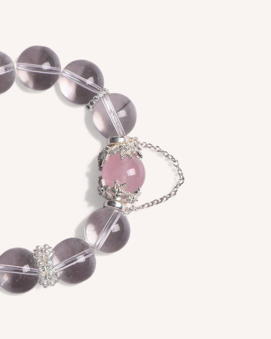 Side view of the Love & Clarity Rose Quartz Bracelet showcasing its transparent white crystal beads and delicate rose quartz charm, designed for emotional healing and positivity.