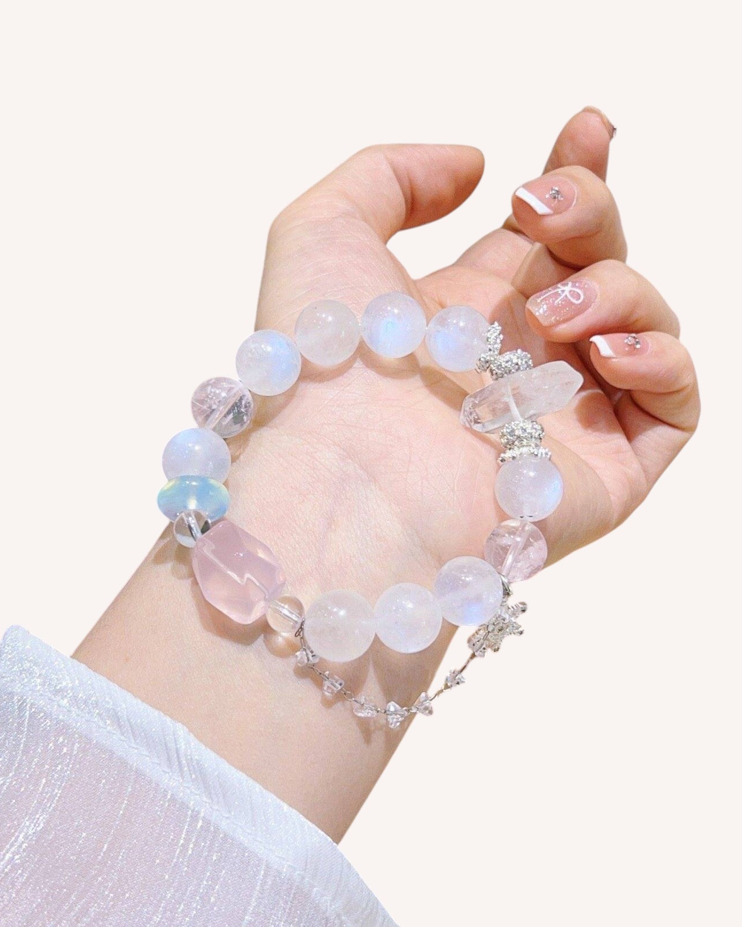 Model wearing Moonstone and Rose Quartz bracelet for intuition and peace, side wrist view