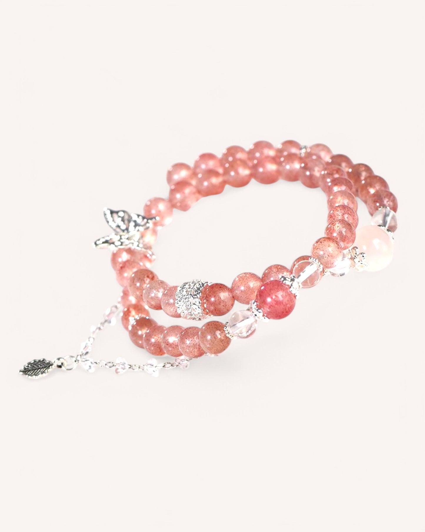 Side angle of triple-layer crystal bracelet featuring Strawberry Quartz, Pink Quartz, and White Quartz for love, balance, and energy cleansing.