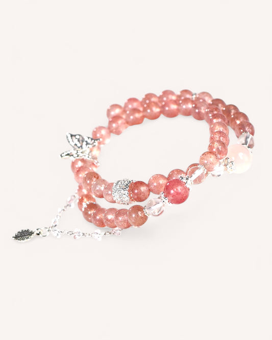 Side angle of triple-layer crystal bracelet featuring Strawberry Quartz, Pink Quartz, and White Quartz for love, balance, and energy cleansing.