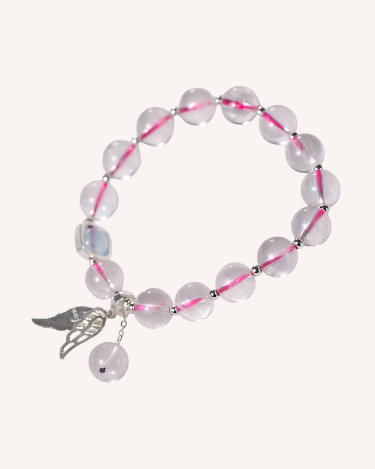 Rose Quartz and Aquamarine crystal bracelet with silver angel charm, promoting emotional balance, inner peace, and divine connection.