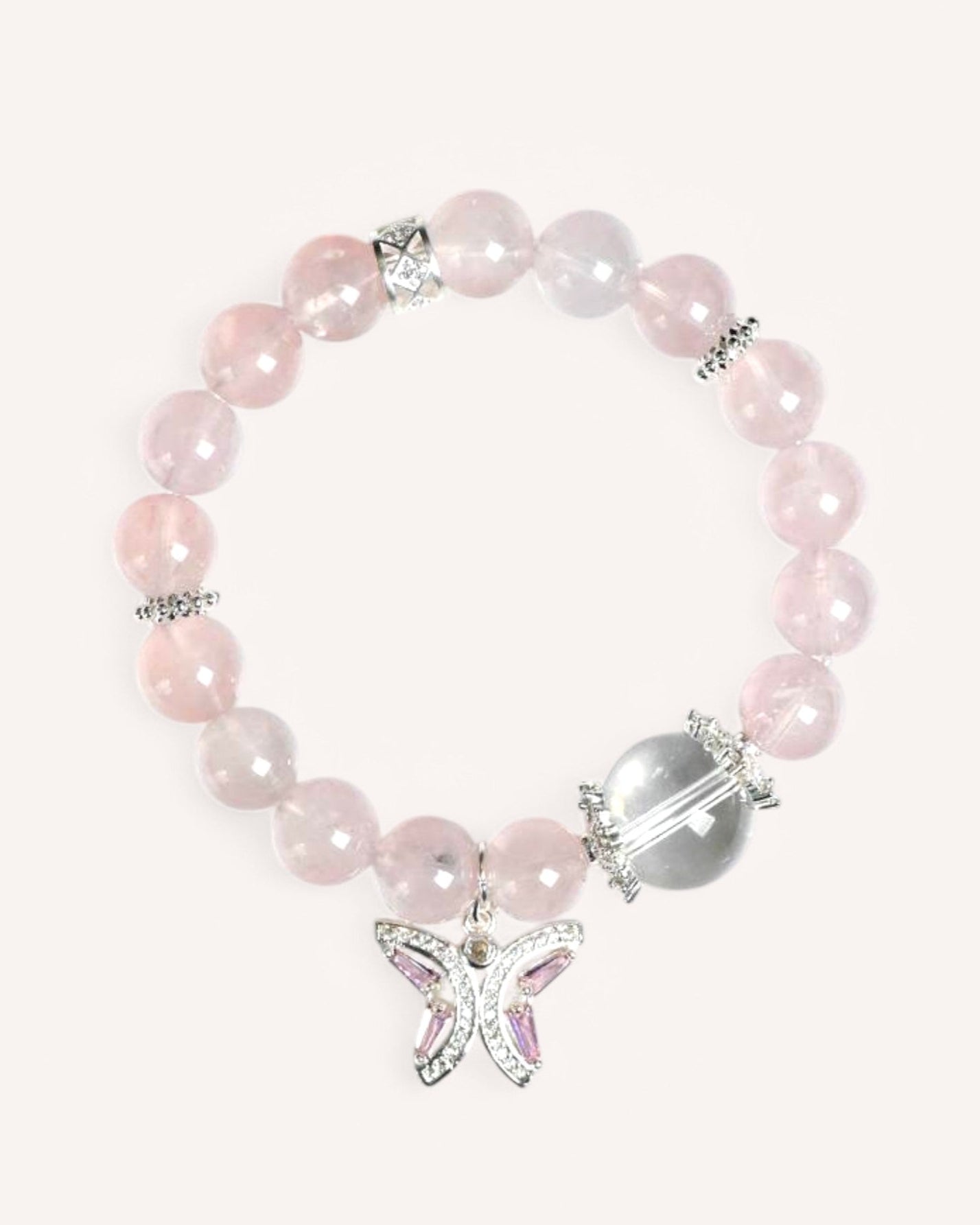 A delicate Rose Quartz and White Quartz bracelet with a butterfly charm, symbolizing love, renewal, and feminine energy.
