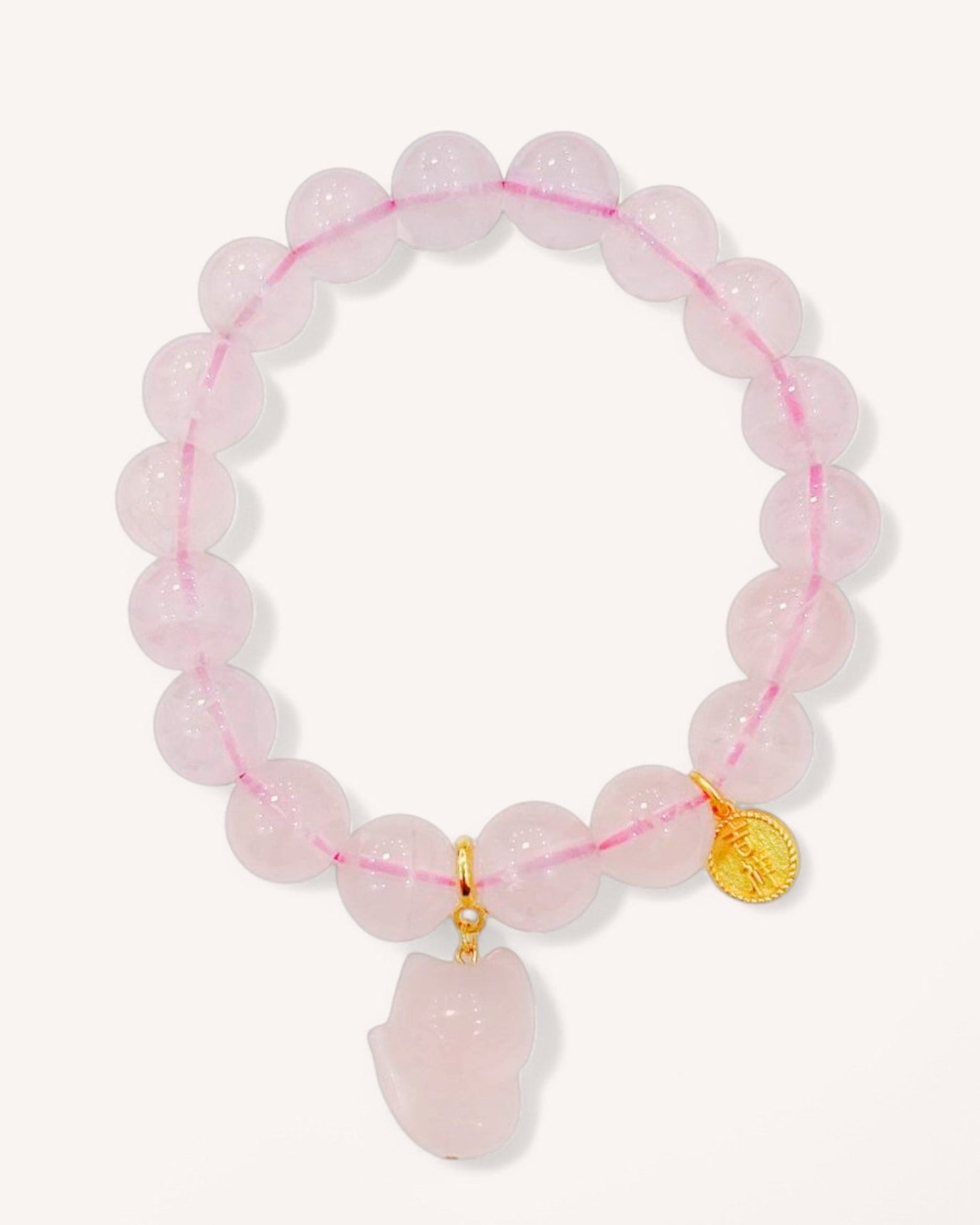 Rose Quartz bracelet with fox charm for love, protection and emotional healing, featuring pink crystal beads on elastic string.