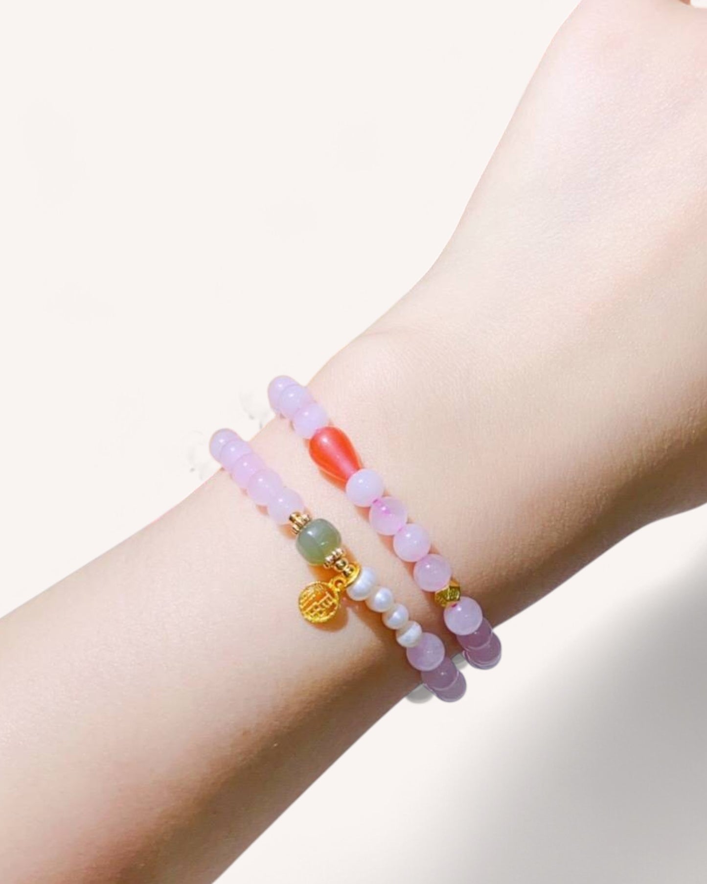 Rose Quartz, Hetian Jade, and Southern Red Agate healing bracelet worn on wrist, promoting love, protection, and emotional balance.