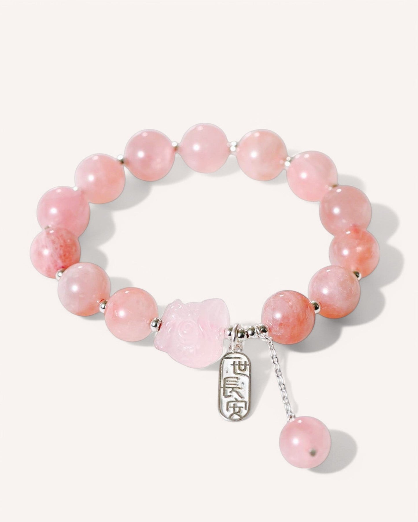 Self-love and protection crystal bracelet with rose quartz and silver fox charm, showcasing gemstone clarity and heart chakra healing energy.