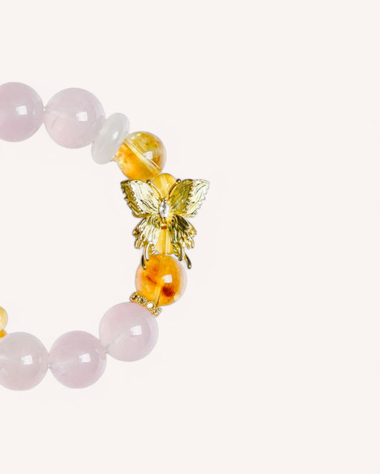 Close-up detail of Rose Quartz and Yellow Azeztulite bracelet featuring a golden butterfly charm for love attraction and positive energy alignment.