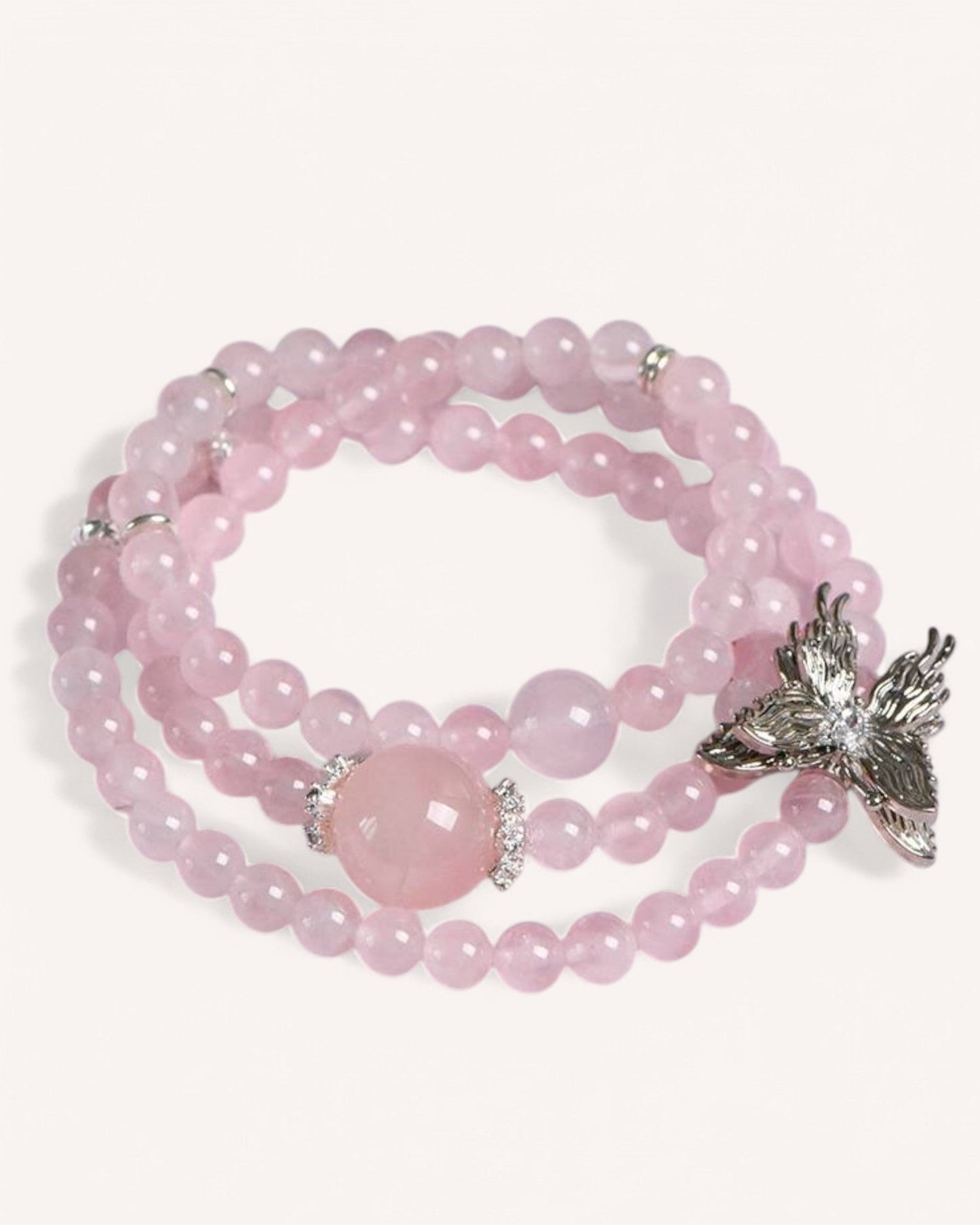 Elegant Rose Quartz wrap bracelet with a butterfly charm, symbolizing transformation, self-love, and emotional healing.
