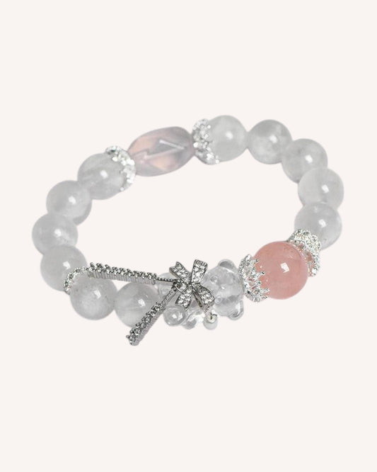 Side angle of the Snow Phantom, White Quartz, and Rose Quartz Bracelet with dragonfly charm, symbolizing self-love, tranquility, and spiritual balance